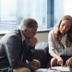 Lawyers and business colleagues reviewing contract documents together in an office meeting