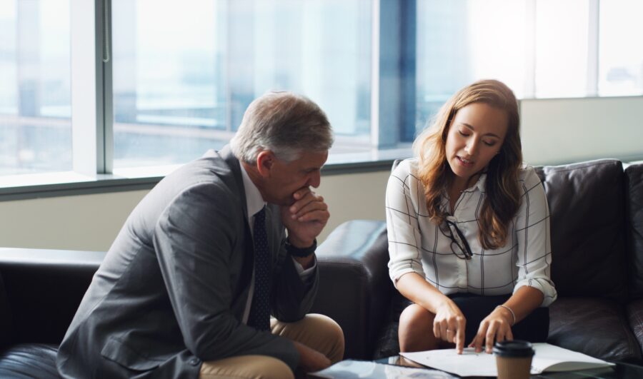 Lawyers and business colleagues reviewing contract documents together in an office meeting
