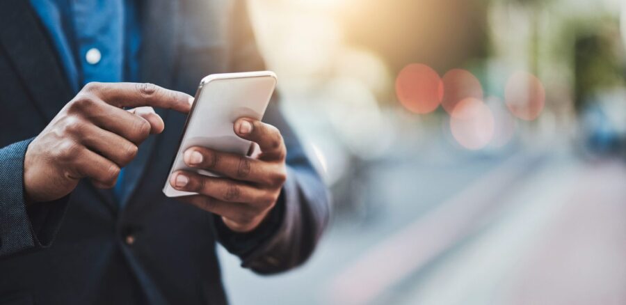 Business professional taking a phone call on a mobile phone outside an office
